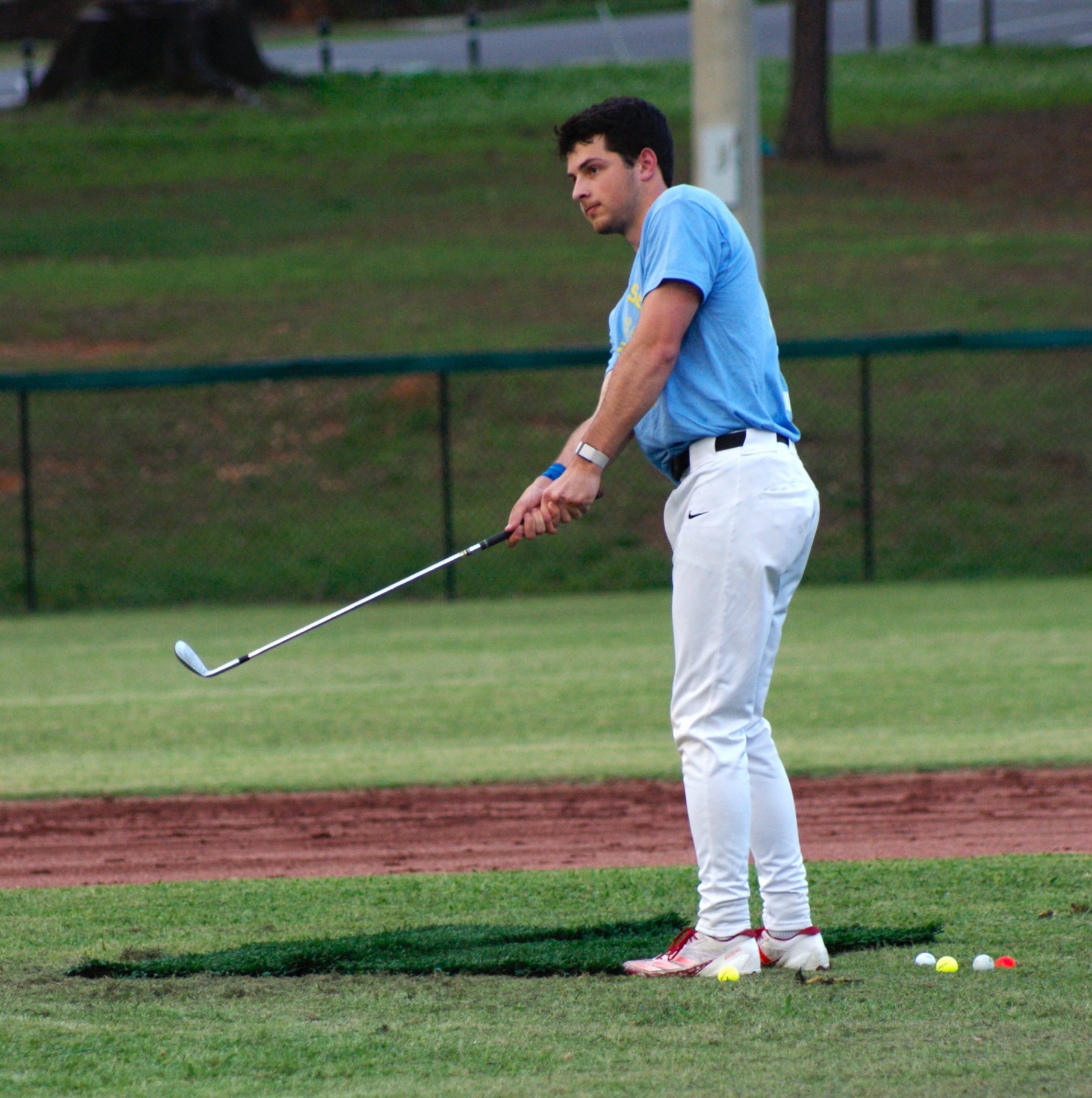 A Team Sigma Chi player chips a golf ball during the Closest to the Pin Challenge.
